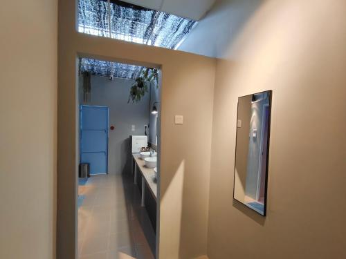 a bathroom with a sink and a mirror on the wall at TREASURE BOX At Heritage Georgetown in George Town