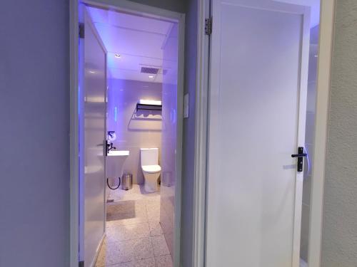 a bathroom with a toilet and a sink at TREASURE BOX At Heritage Georgetown in George Town