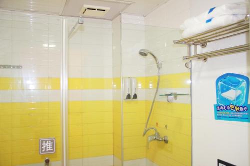 a shower with a glass door in a bathroom at 7Days Inn Nanjing Xuanwumen Subway Station Hunan Road in Nanjing