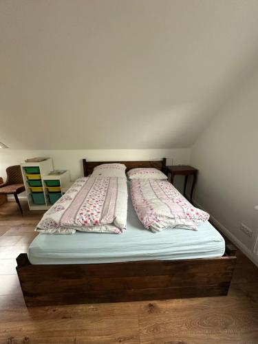 a bed with two pillows on it in a room at Ferienwohnung Ostseefeuer in Eutin