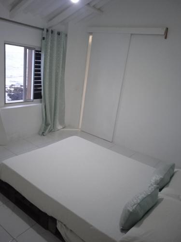 Una cama o camas en una habitación de L2B - São Vicente