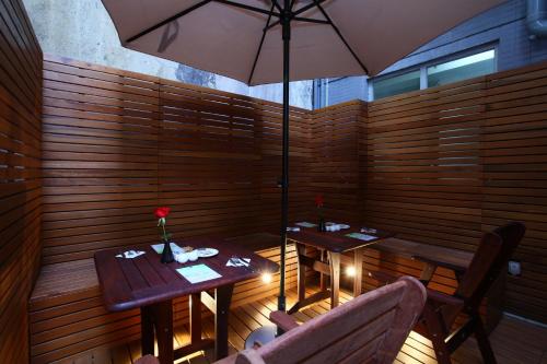 a restaurant with two tables and an umbrella at Sohotel in Hong Kong