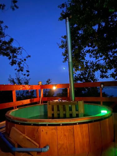 a hot tub on a deck at night at Cabaña entre mares Huelmo in Puerto Montt