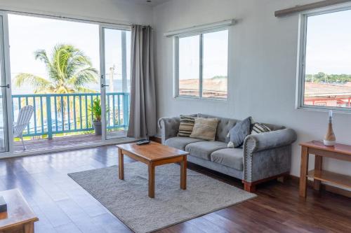 a living room with a couch and a table at Chango's Apartments in Bocas del Toro