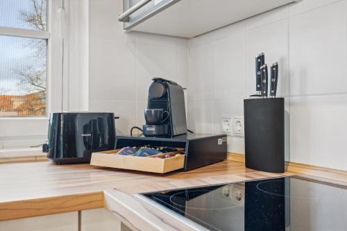 a kitchen with a counter with a microwave and a appliance at maremar - Design-Maisonette am Holzmarkt - Luxus Boxspringbetten - Arbeitsplatz - Loggia in Verden