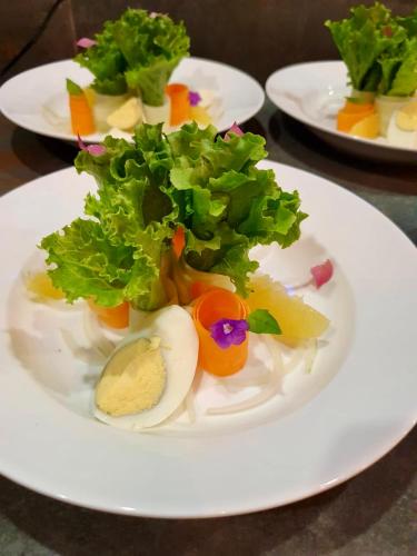 a plate of food with lettuce and eggs on a table at Southern Drake Lodge in Drake