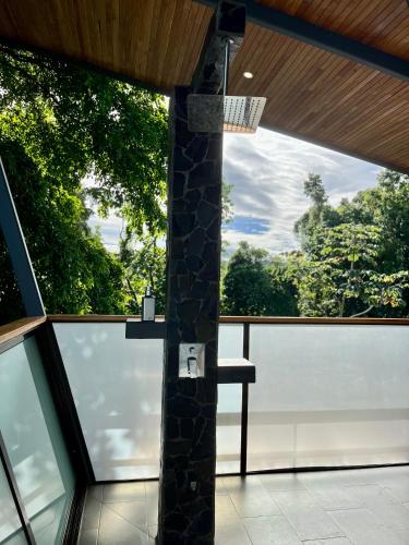 a room with a pillar and a chair on a balcony at Southern Drake Lodge in Drake