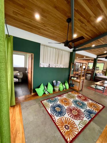 a living room with green walls and a rug at Southern Drake Lodge in Drake