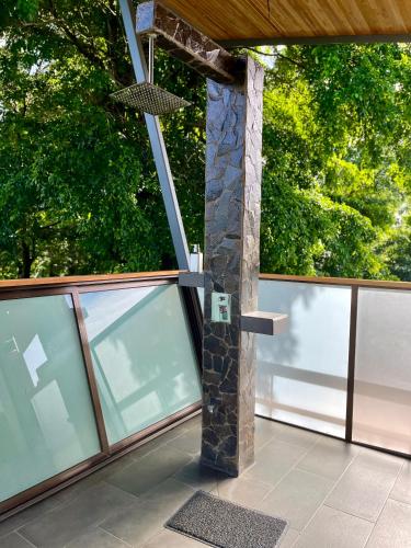 a building with a stone pillar on a balcony at Southern Drake Lodge in Drake