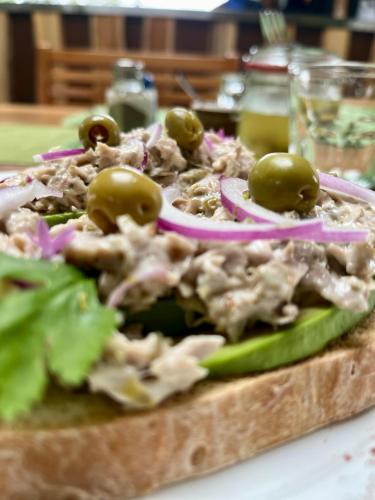 a pizza with olives on top of it on a table at Southern Drake Lodge in Drake