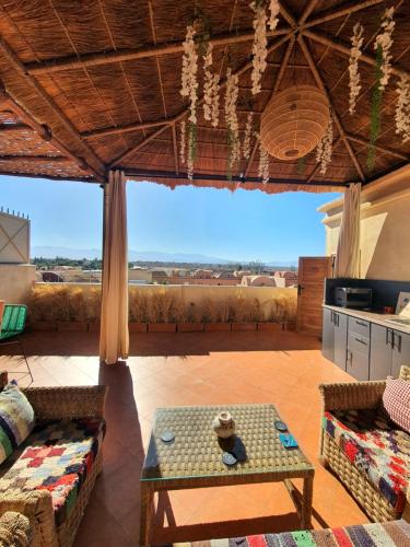 a living room with a table and a large window at Maison Mamdy Rooftop in Marrakech