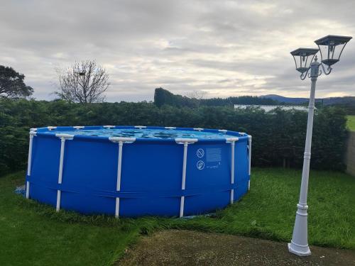 a large blue tub sitting next to a street light at El Rancho Busto - Luarca in Busto