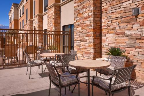 a group of tables and chairs on a patio at SpringHill Suites Thatcher in Thatcher