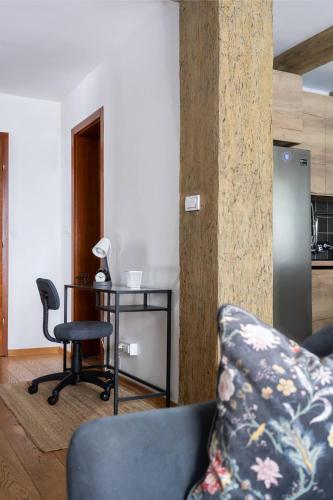 a living room with a couch and a table and a chair at Kežman Mountain Houses in Kopaonik