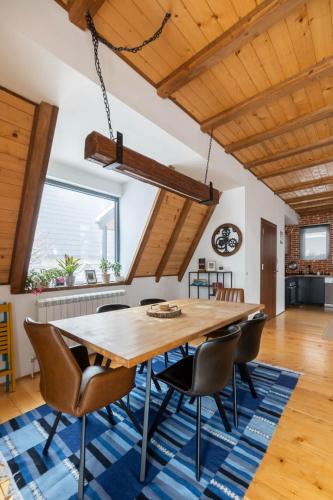 a dining room with a wooden table and chairs at Kežman Mountain Houses in Kopaonik