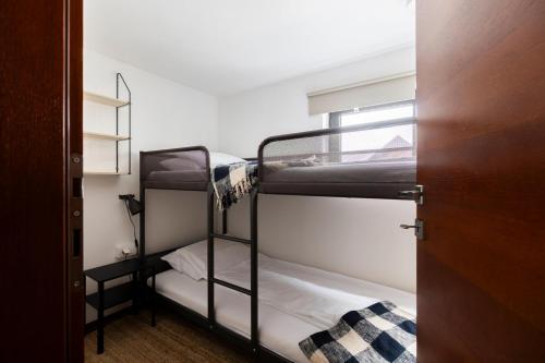 a room with two bunk beds and a door at Kežman Mountain Houses in Kopaonik
