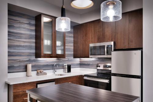 a kitchen with wooden cabinets and a wooden table at Residence Inn by Marriott Sedona in Sedona
