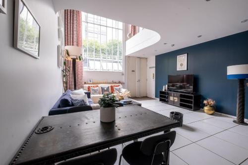 un salon avec une table et un canapé dans l'établissement Loft d Exception au Pied des Champs-Élysées, à Paris