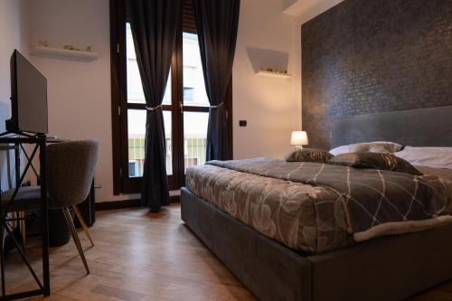 a bedroom with a bed and a desk and a television at V&V art & rooms in Nocera Inferiore