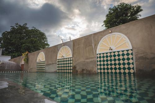 a pool with umbrellas in the middle of it at Jawi Peranakan Mansion in George Town