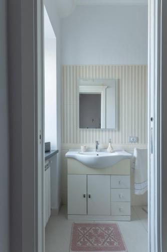 a bathroom with a white sink and a mirror at Le Pendici Casa Vacanze in Boscotrecase