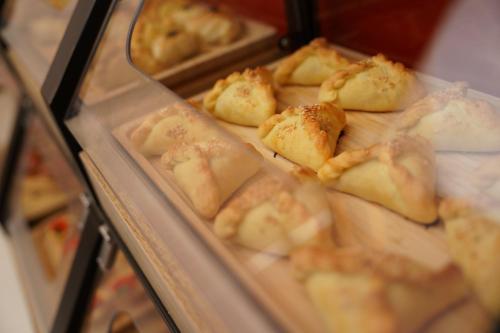 a display case full of food in a bakery at Duo Hotel by Futuro in Bishkek