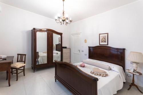 a bedroom with a bed and a large mirror at Le Pendici Casa Vacanze in Boscotrecase