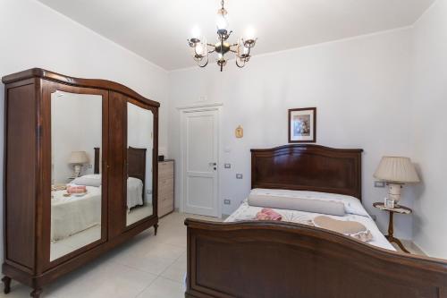 a bedroom with a bed and a large mirror at Le Pendici Casa Vacanze in Boscotrecase