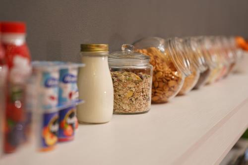 a shelf with jars of food and bottles of milk at Duo Hotel by Futuro in Bishkek