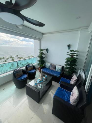a living room with couches and a view of the ocean at Beachfront Apartment with Jacuzzi in Juan Pedro