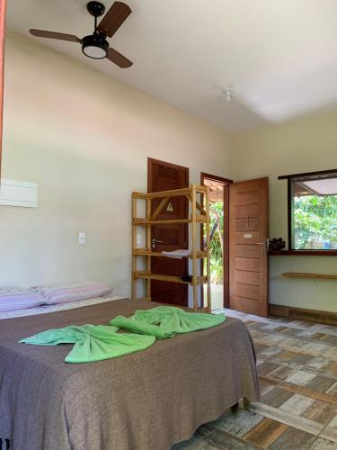 a bedroom with a bed with a ceiling fan at PachaMama Flats - Taipu de Fora in Barra Grande