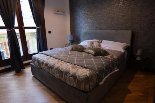 a dog laying on a bed in a bedroom at V&V art & rooms in Nocera Inferiore