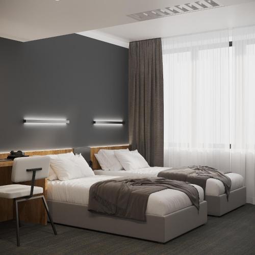 a bedroom with two beds and a desk and a window at Duo Hotel by Futuro in Bishkek