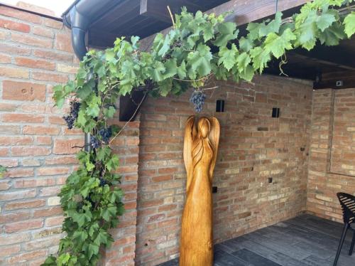 a statue of a woman hanging on a brick wall at Apartmány Lednice Václavkova 206 in Lednice