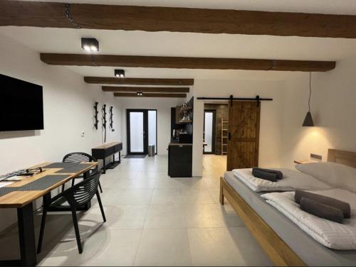 a living room with a bed and a dining table at Apartmány Lednice Václavkova 206 in Lednice