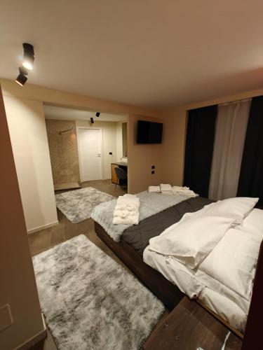 a bedroom with a large bed with towels on it at Hotel La Thuile Resort & SPA in La Thuile