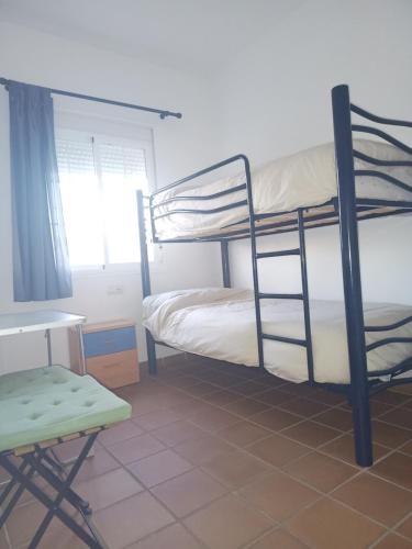 a room with two bunk beds and a desk at Apartamento Islantilla Club in Islantilla