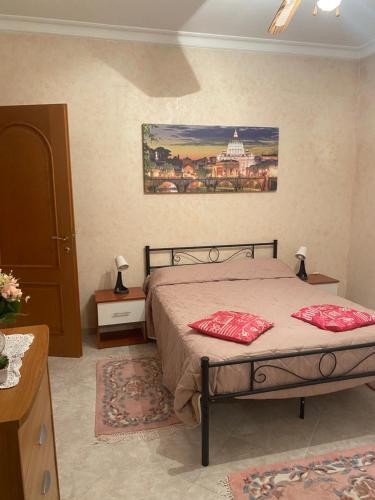 a bedroom with a bed with two pillows on it at CasadellemeravigliediGiulia in Ostia Antica