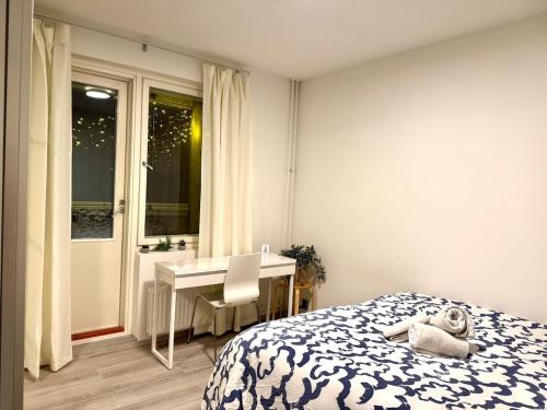 a bedroom with a bed and a desk with a teddy bear on it at Free Parking Private ROOM with Balcony, 10mins to Helsinki center in Helsinki