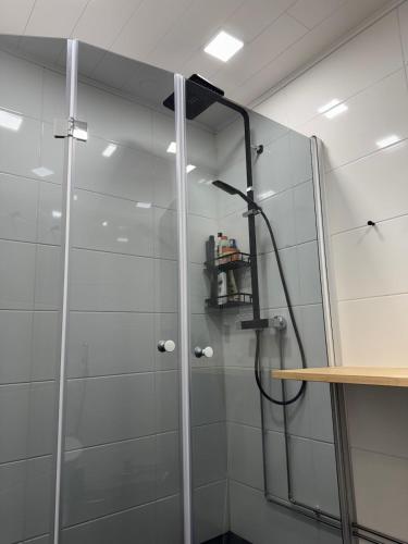 a shower with a glass door in a bathroom at Free Parking Private ROOM with Balcony, 10mins to Helsinki center in Helsinki