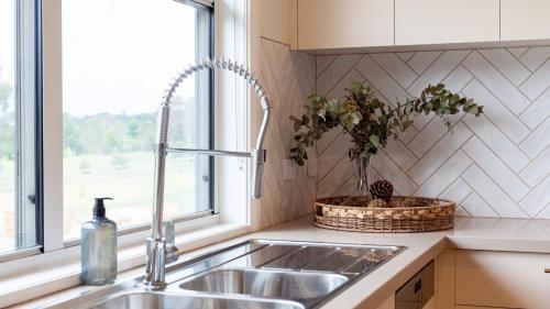 a kitchen counter with a sink and a window at Misty Pond in Berrima
