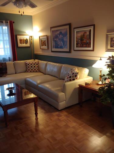 a living room with a couch and a table at 3 Bedrooms 3 beds near metro -2 Parking Free in Montréal