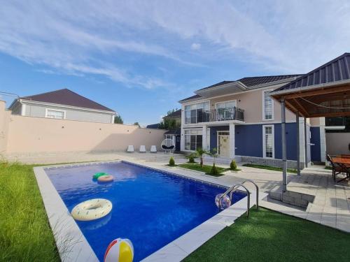 a swimming pool in the backyard of a house at Rest Paradise Villa Gabala in Gabala