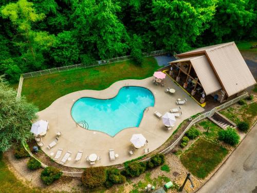 an overhead view of a swimming pool with a house at Pet Friendly Family Cabin with Hot Tub & Game Room Near Dollywood in Pigeon Forge