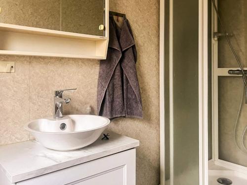 a bathroom with a white sink on a counter at 4 person holiday home in LÖNASHULT in Lönashult