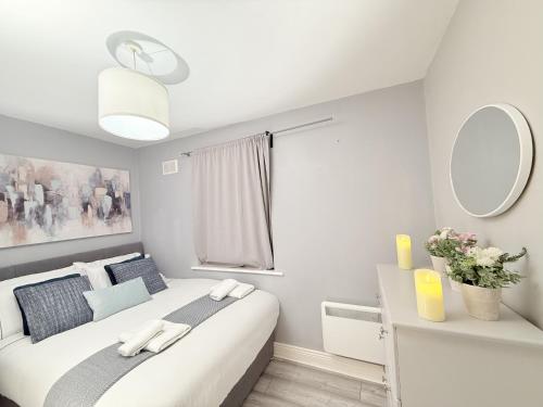 a bedroom with a large white bed with a mirror at Apartment In Best Location Dublin in Dublin