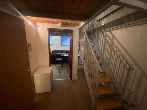 a hallway with stairs leading to a room with a desk at City centre Apartment in Nottingham