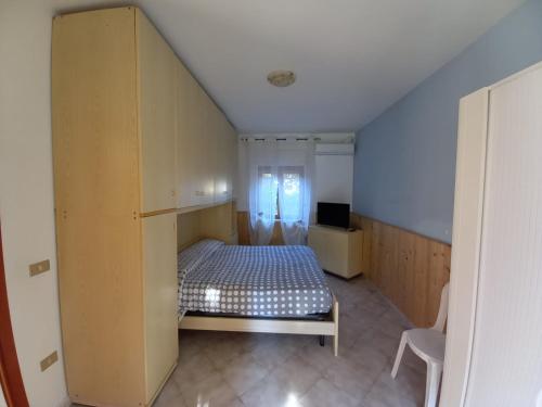 a bedroom with a bed in a room with a window at Villa Elena in Minturno