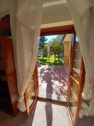 a large glass door with a view of a patio at Villa Elena in Minturno