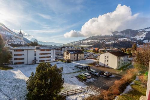 an aerial view of a city with buildings and mountains at Edelweiss in Charmey